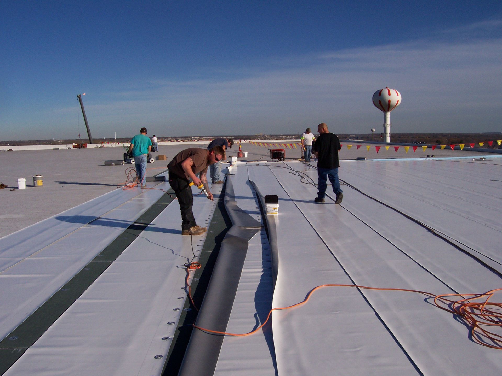 Workers On A Rooftop — Seymour, WI — Northeastern Roofing Company