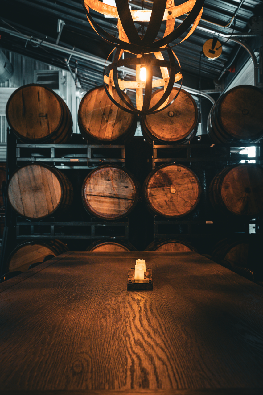 A Woman Holding a Whiskey Cocktail From Six-Mile Ordinary in Columbia, MO.