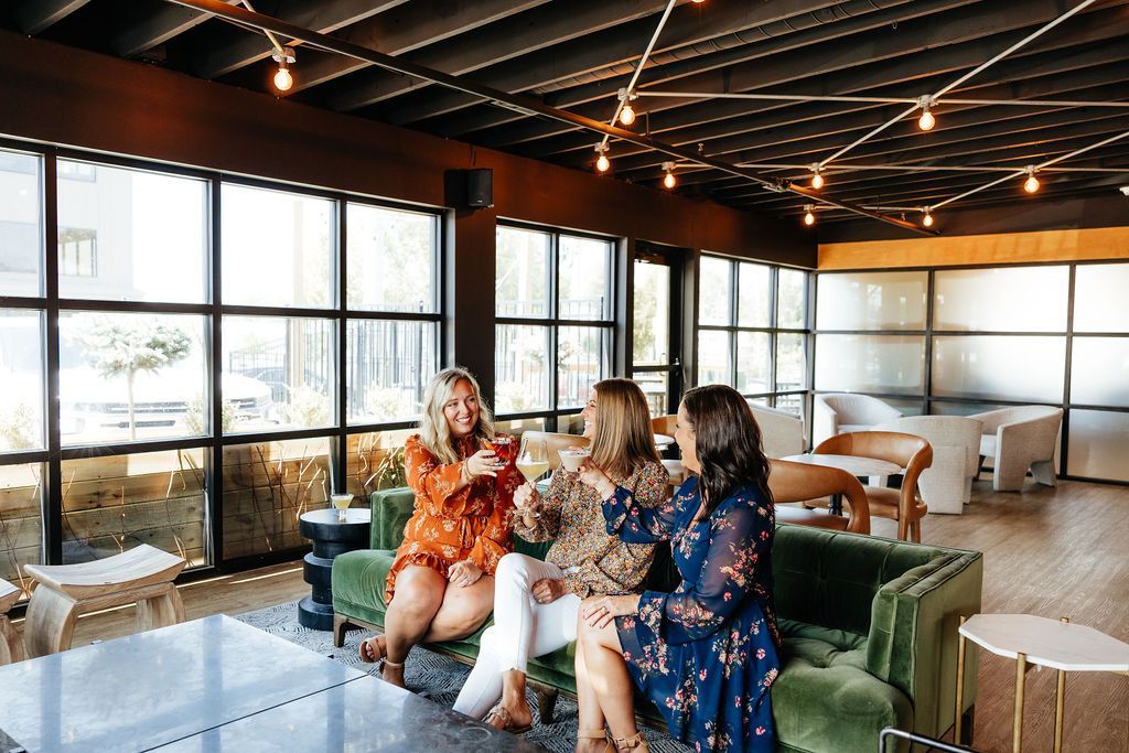 Three Women Cheering Their Drinks in the Tasting Room at Six-Mile Ordinary.
