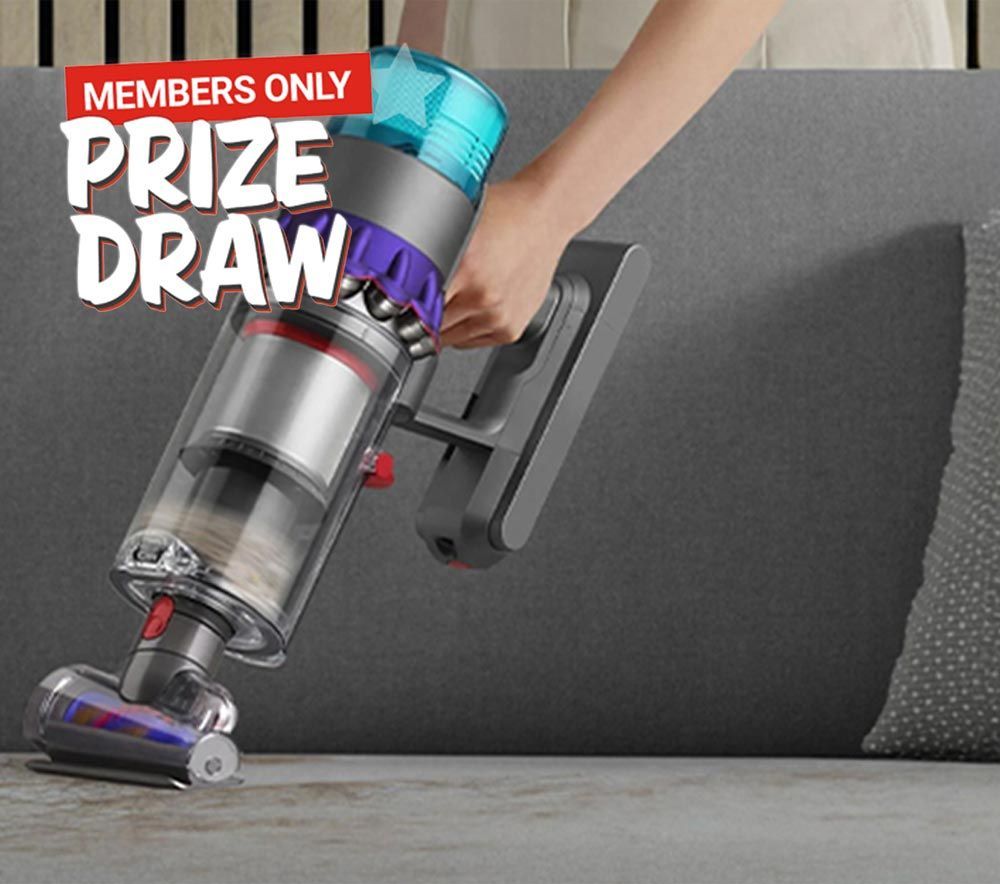 A person is using a vacuum cleaner on a couch in a prize draw