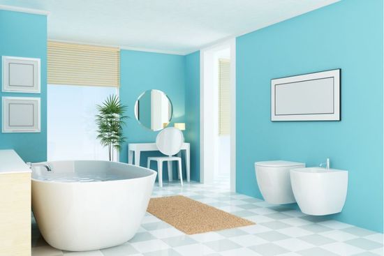 Bright blue bathroom with white fixtures, including a tub and toilet, with a neutral-colored rug.