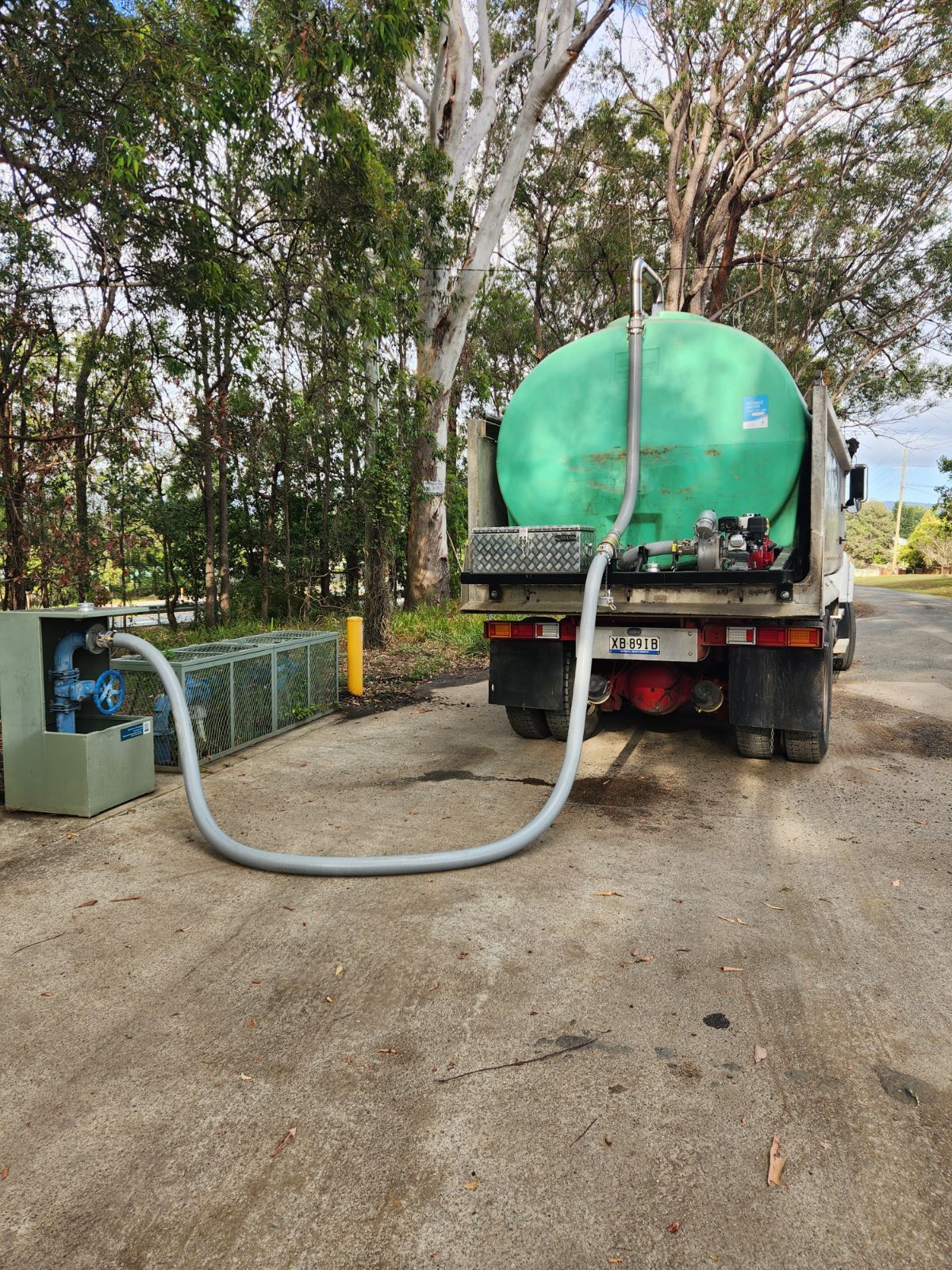 A White Water Truck Is Driving Down A Road — LTR Water Deliveries In Wamuran, QLD