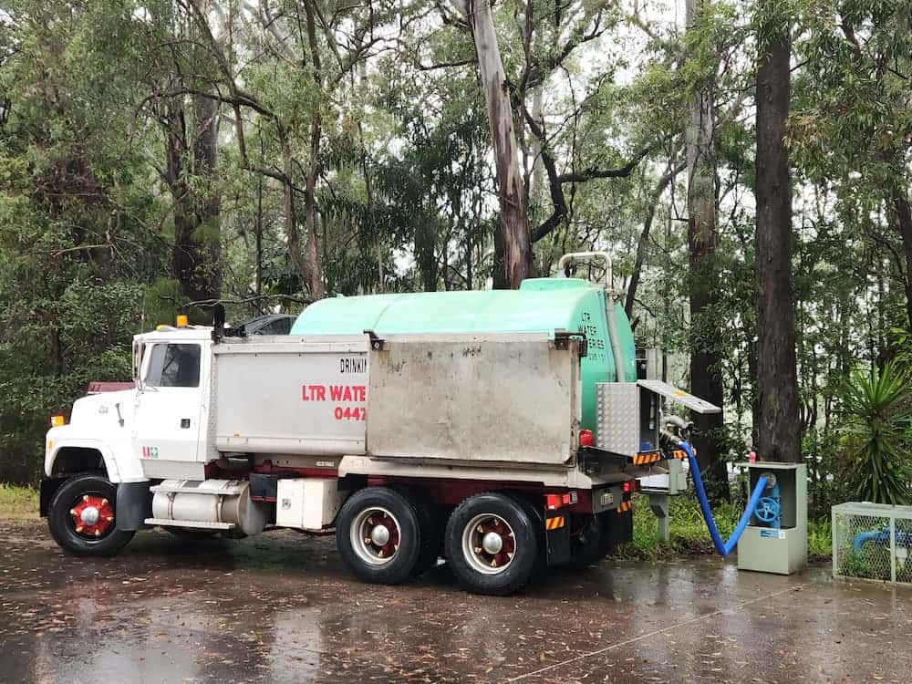 A Water Tank Truck On The Back Of A Parking Lot — LTR Water Deliveries In Wamuran, QLD