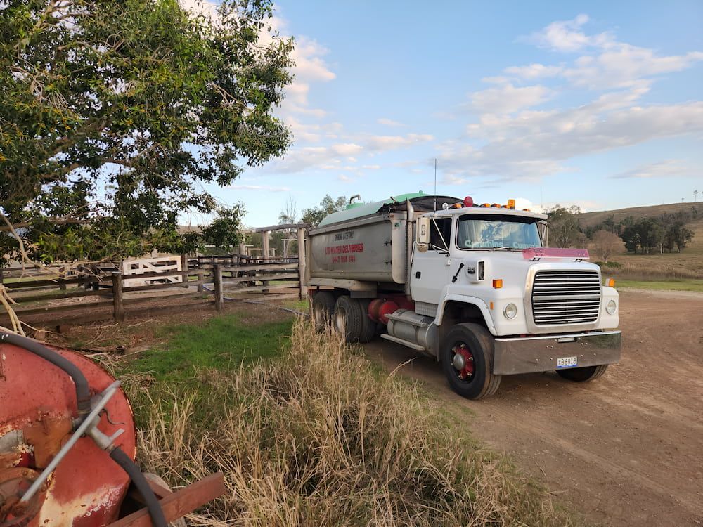 A Water Truck Is Parked On The Side Of A Dirt Road — LTR Water Deliveries In Wamuran, QLD