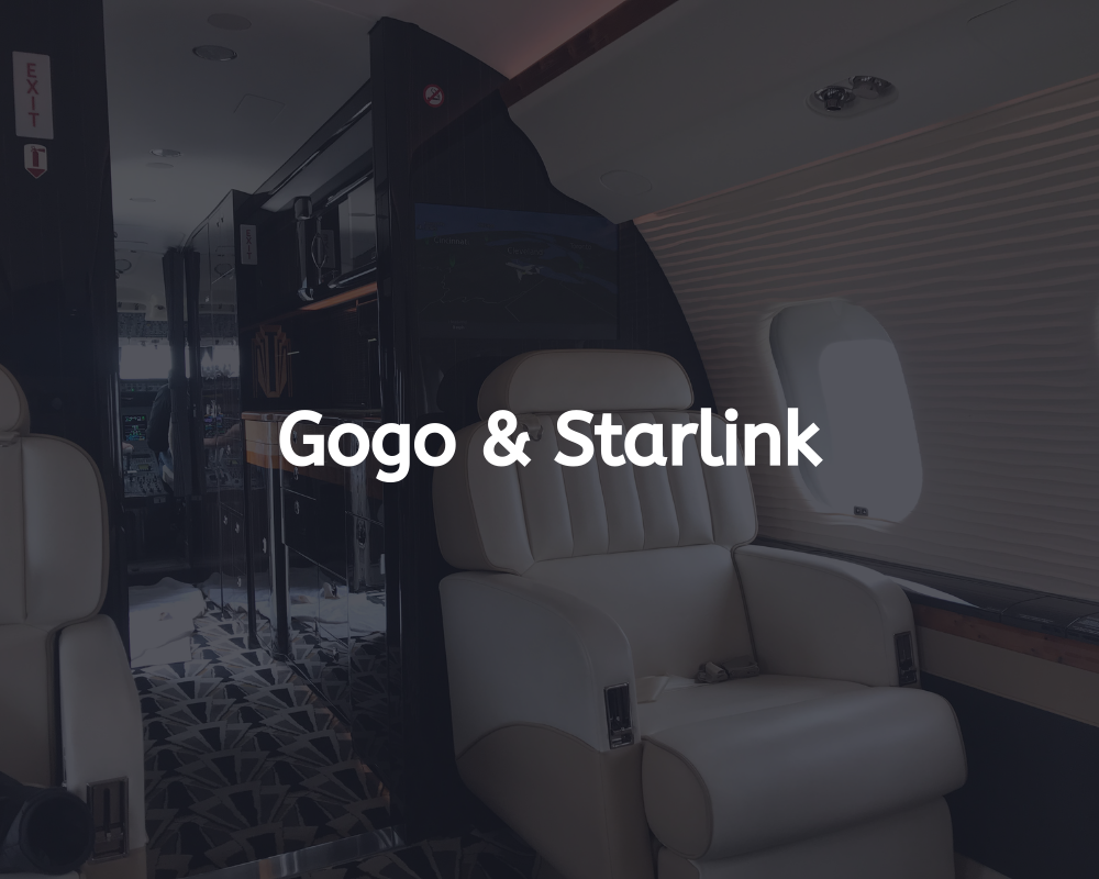 Gogo & Starlink text overlay on the interior of a private jet with white leather seats and dark wood accents.