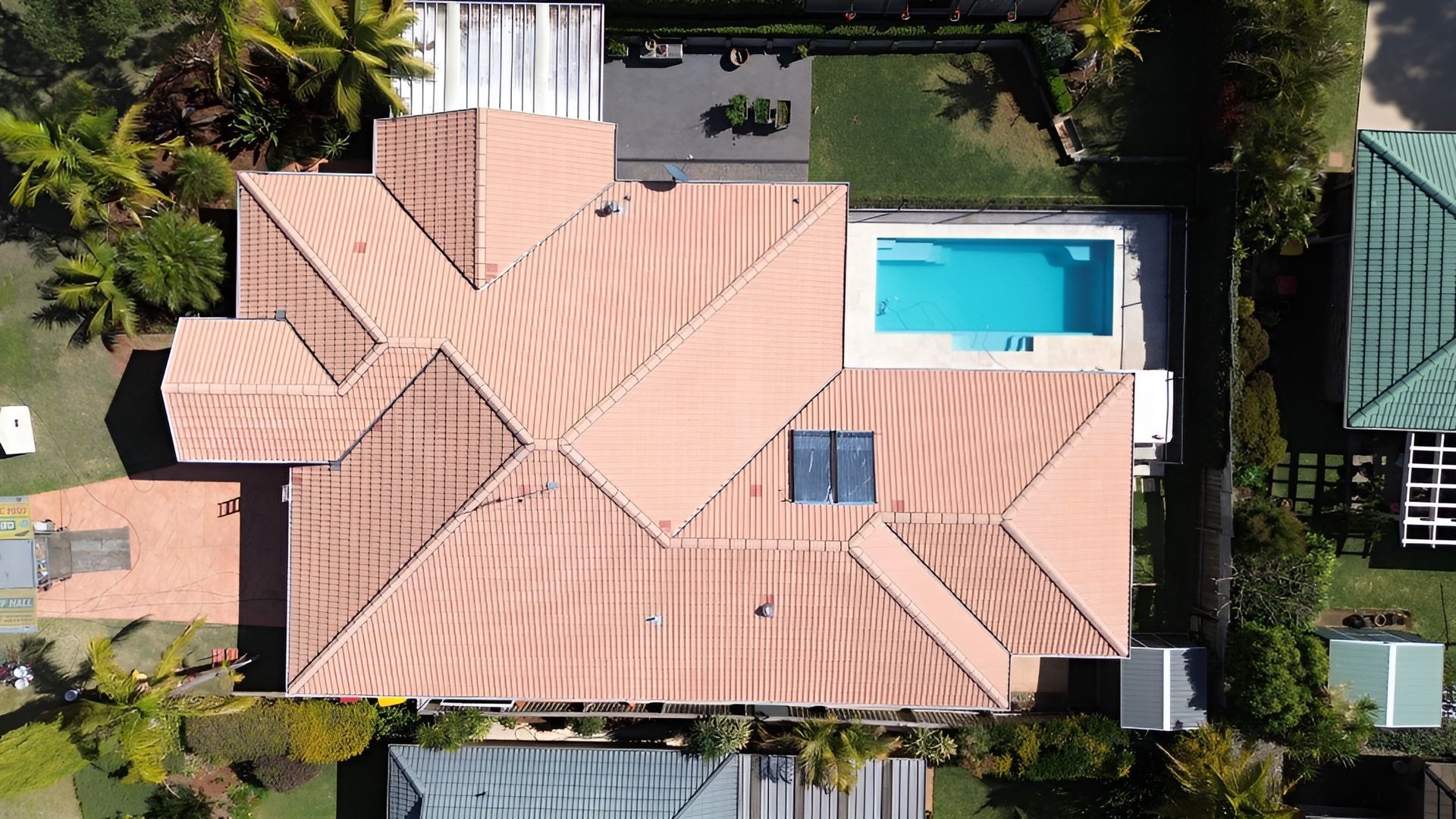 Overhead View of A House with A Pool and Terracotta Roof — Geoff Hall Roofing in Mid North Coast, NSW