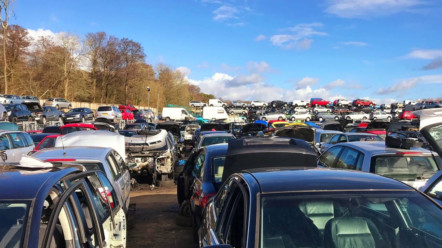 A lot of cars are parked in a lot.
