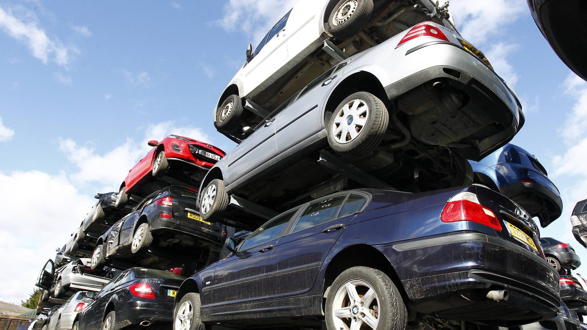 A bunch of cars are stacked on top of each other