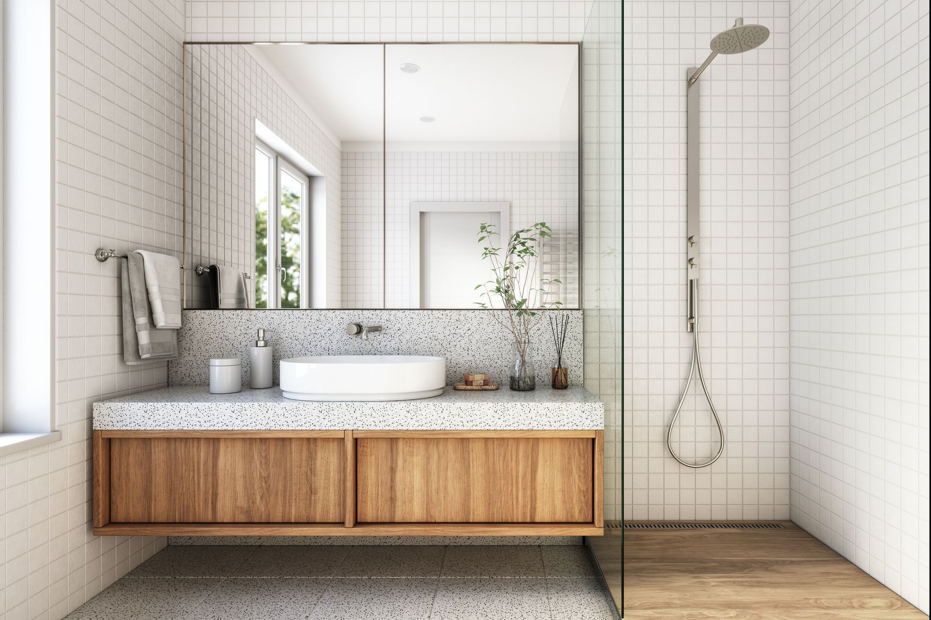Bathroom with floating wooden vanity, terrazzo countertop, white sink, and tiled walls. Glass shower enclosure.