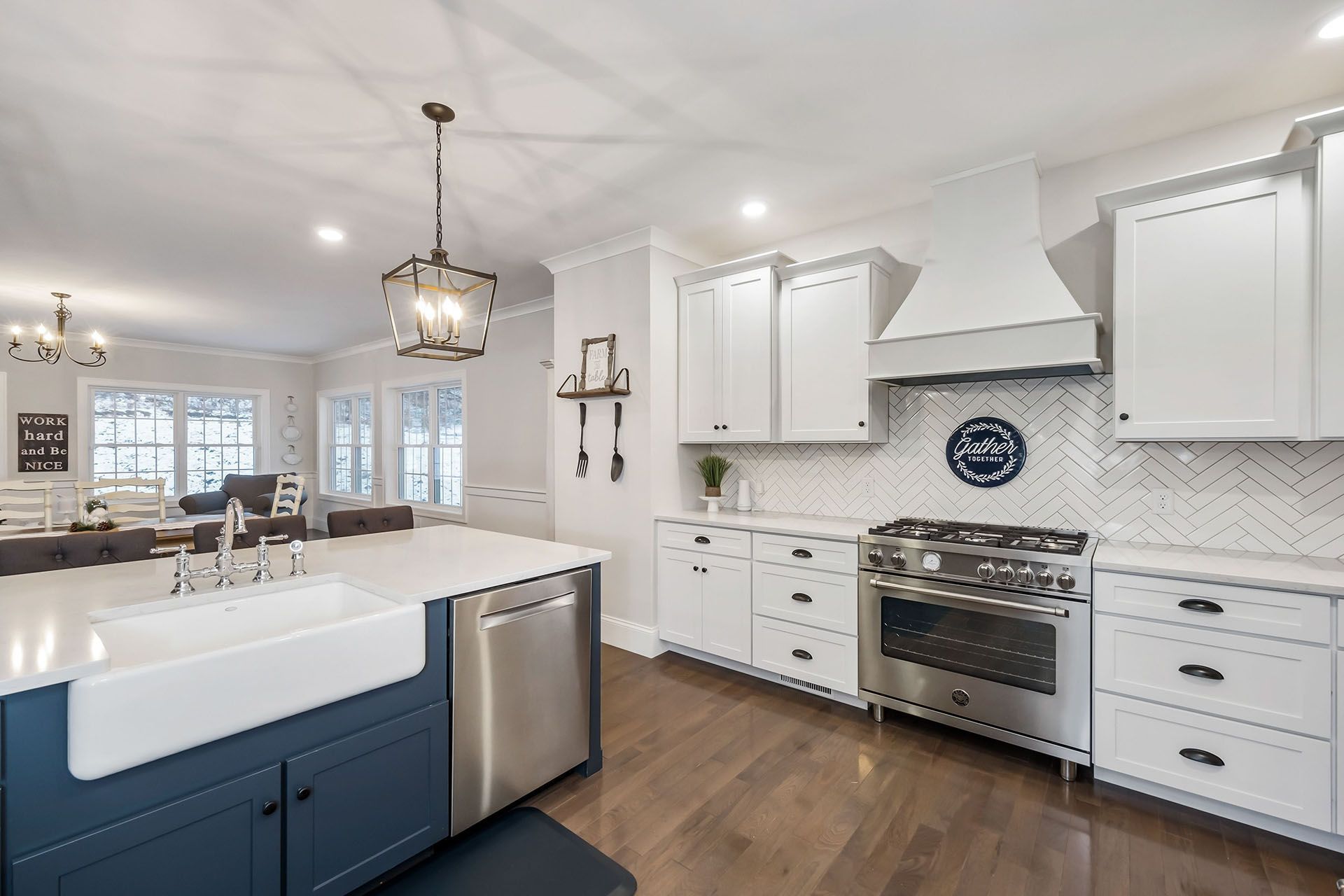 Contemporary kitchen with white cabinetry and island sink