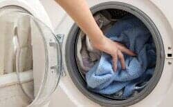 Putting Clothes on Washing Machine — Washing Machine in Schenectady, NY
