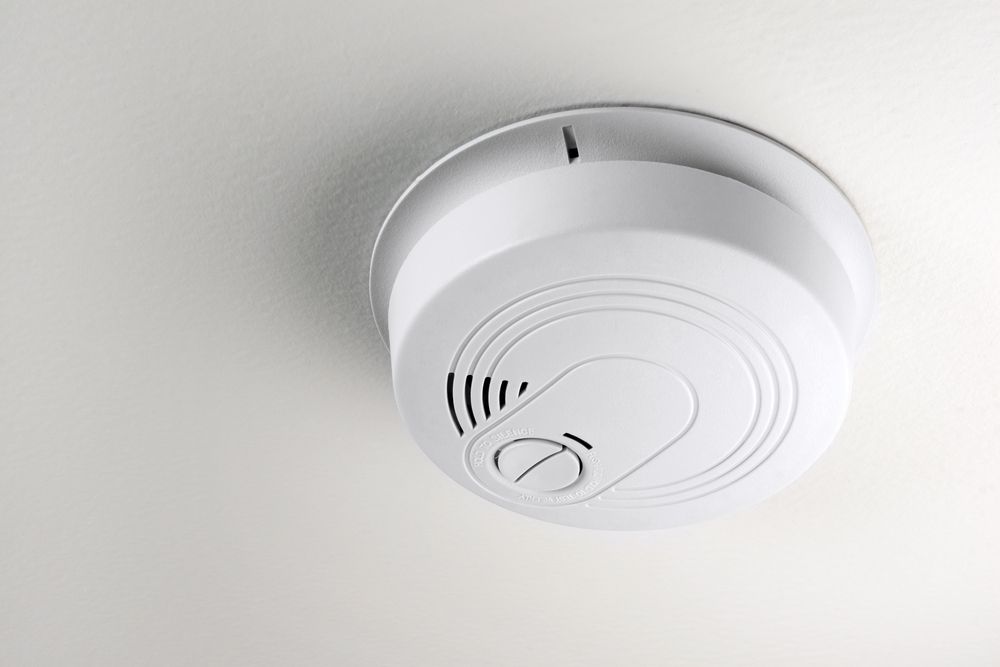 Smoke Detector Attached to a White Ceiling — EBS NQ Electronic Building Systems in Kirwan, QLD