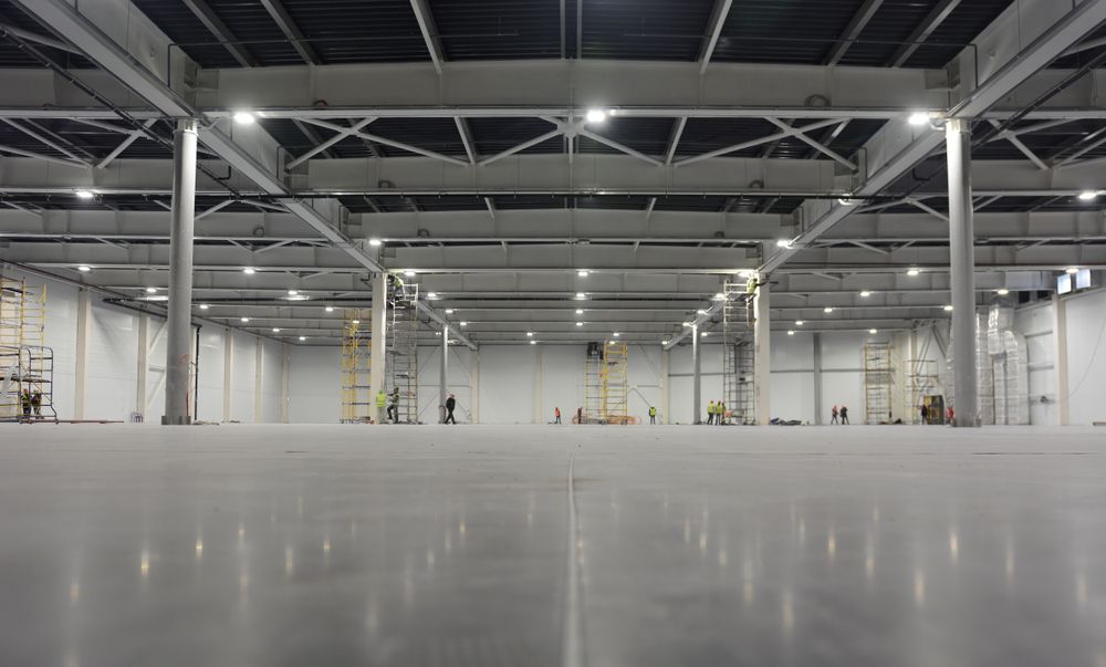 Empty Industrial Warehouse With Polished Concrete Floor — EBS NQ Electronic Building Systems in Kirwan, QLD
