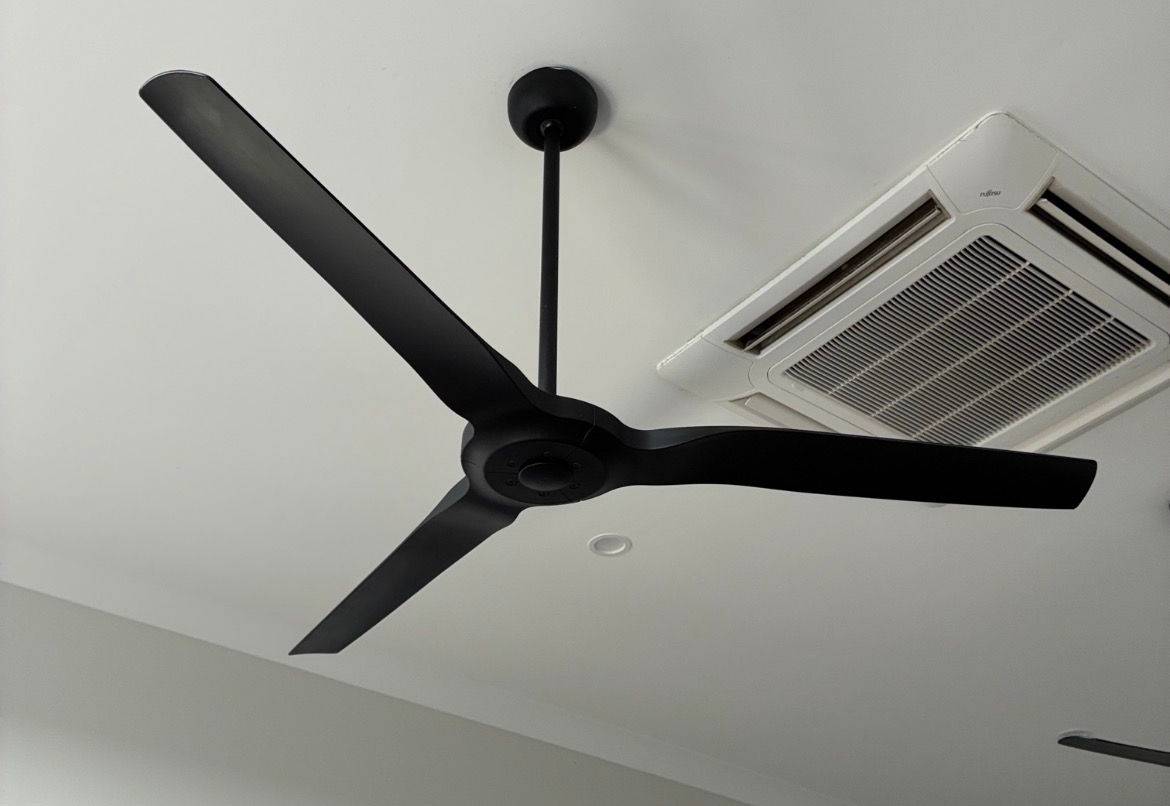 Ceiling fan with five blades, brown and white, above a window with blinds — EBS NQ Electronic Building Systems in Kirwan, QLD