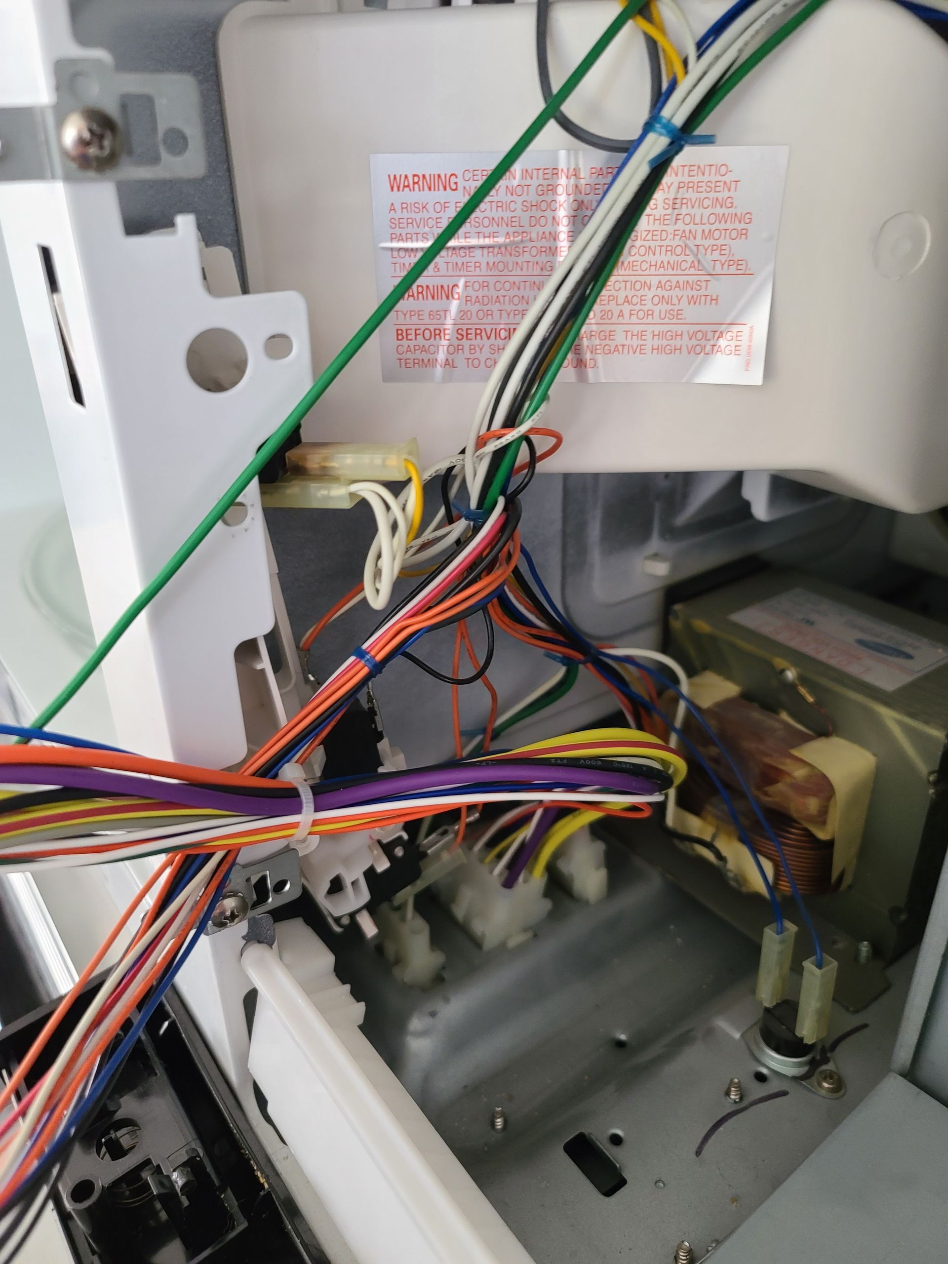 A large house with a garage and a driveway on a rainy day.