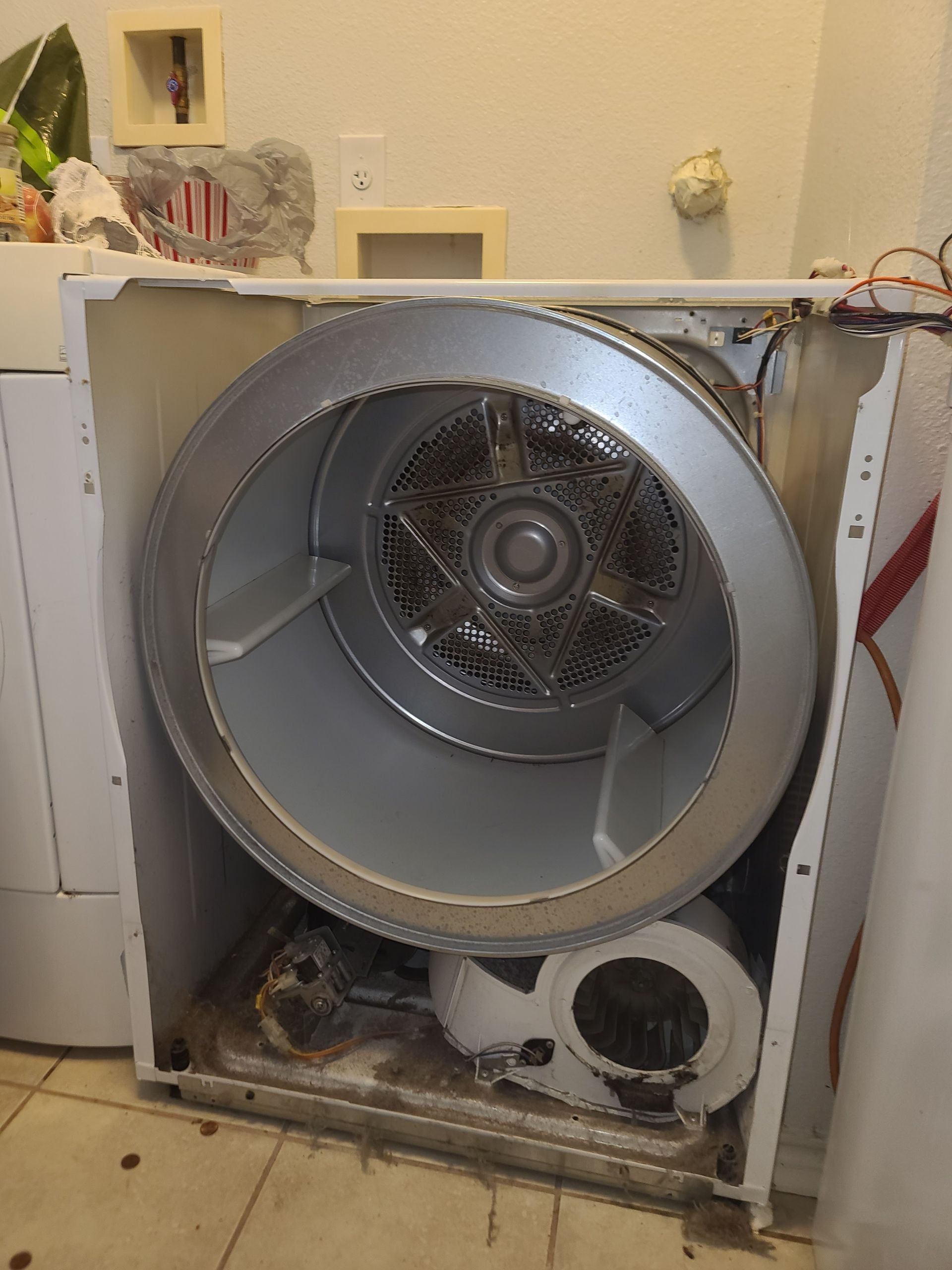A large house with a lot of windows and a garage on a rainy day.