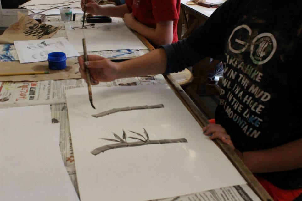 student painting bamboo trees