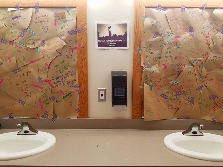 bathroom mirror covered up with positive quotes