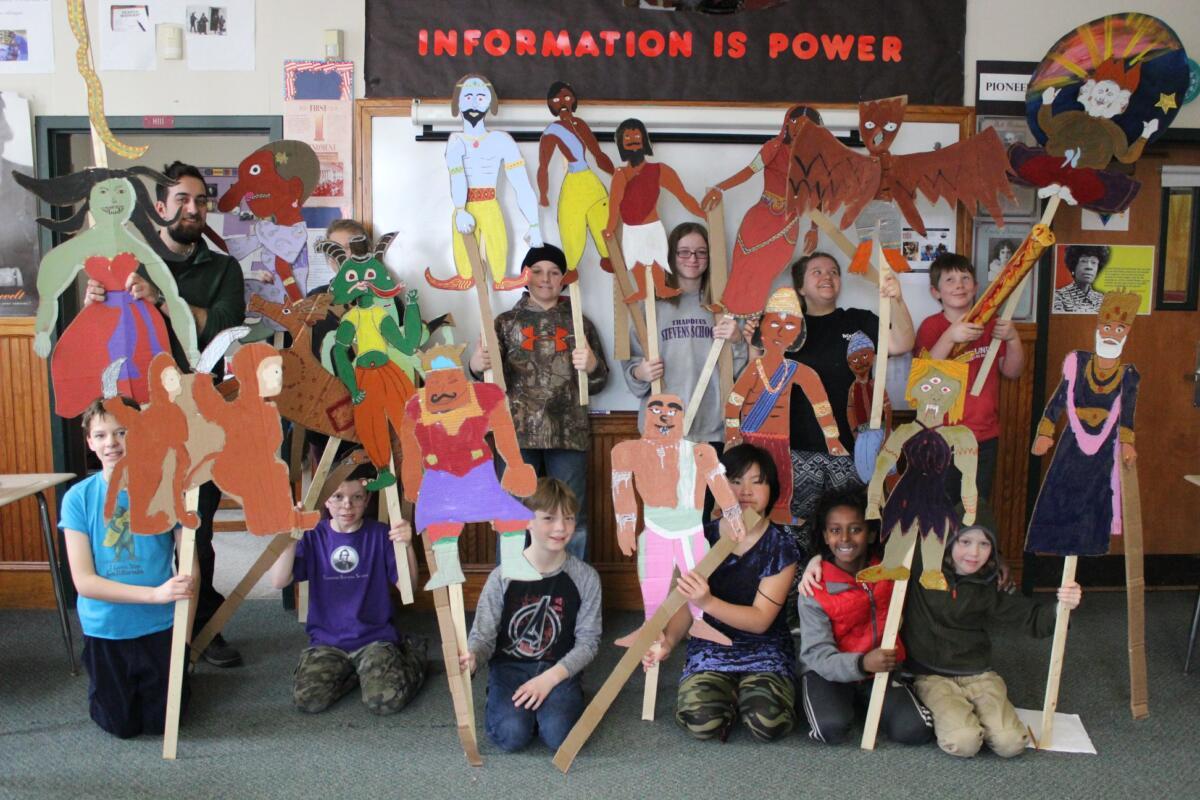 group of students standing together displaying their art projects