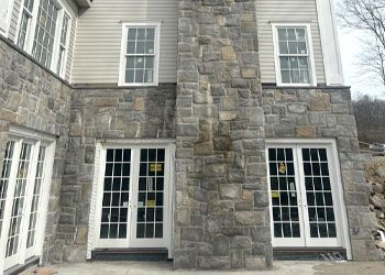 A large stone building with a lot of windows and doors.
