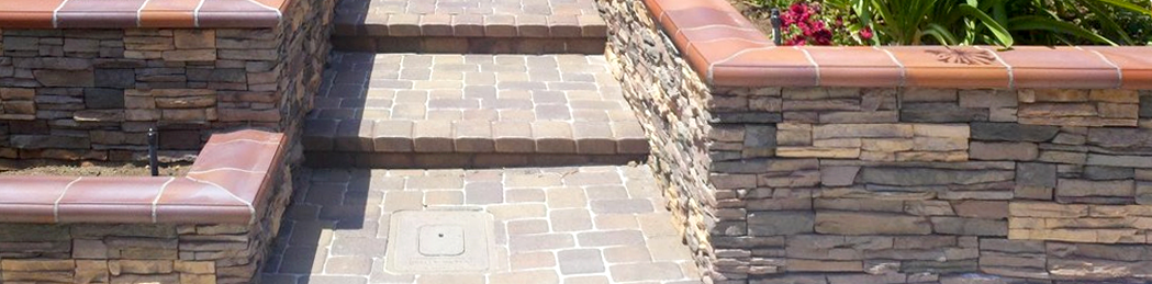 A set of stairs leading up to a stone wall.