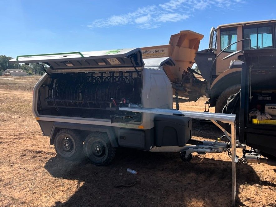 A Generator With The Door Open And A Yellow Truck Behind It — Wyatt Mechanical Pty Ltd In Wodonga, VIC