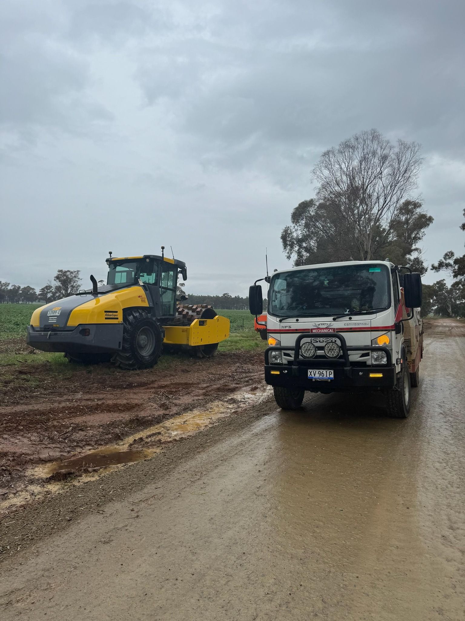 A Truck And Bulldozer Parked On A Dirt Road — Wyatt Mechanical Pty Ltd In Wodonga, VIC