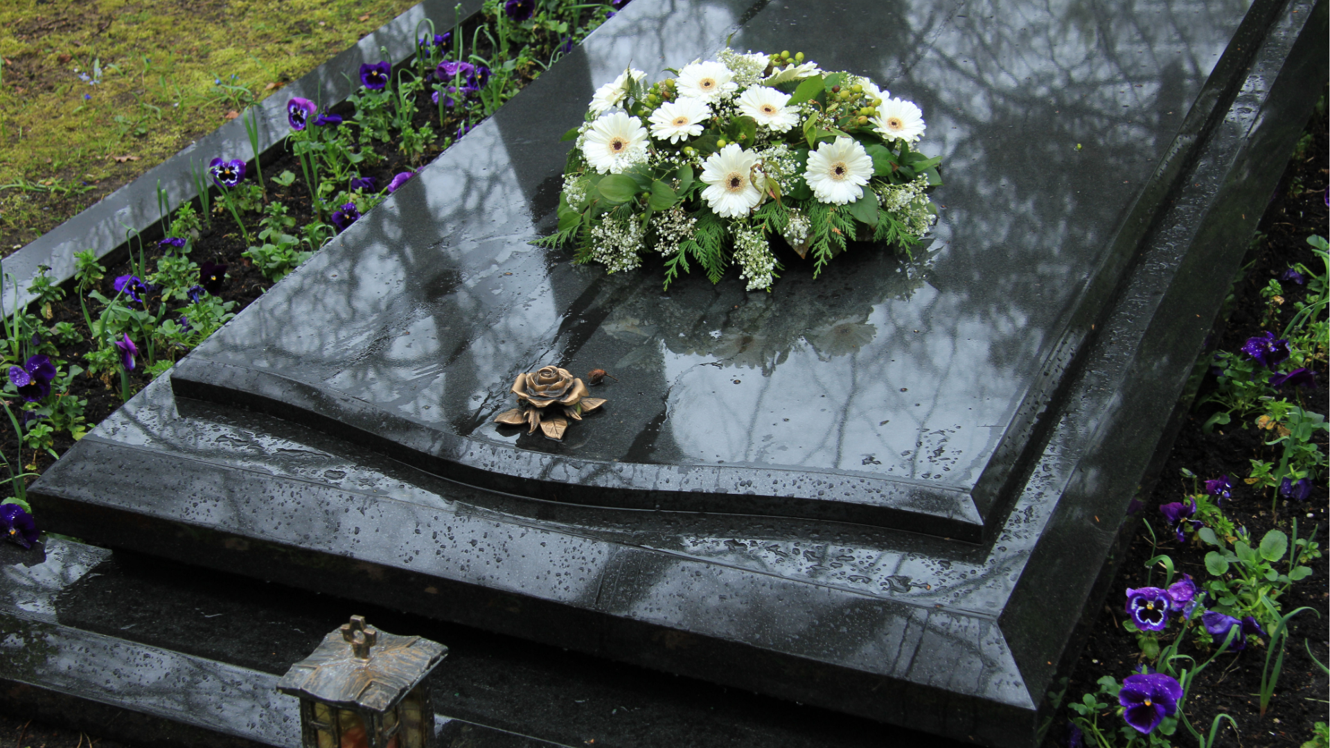 White casket with red and white flowers in a church.