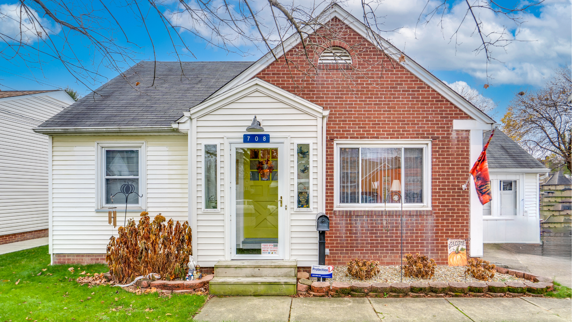Woman in black suit speaking with smiling couple at desk.