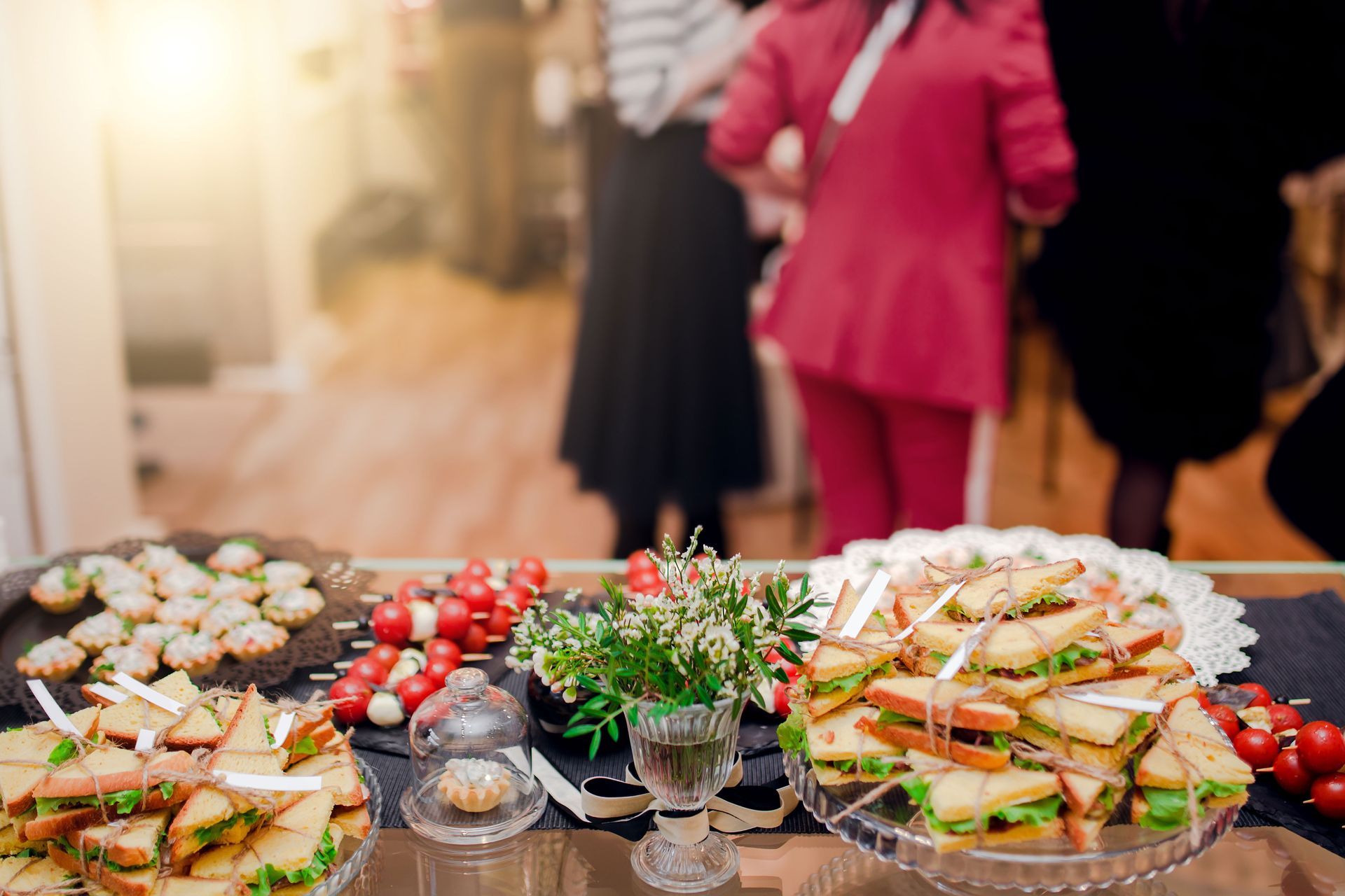 a table topped with a variety of sandwiches and appetizers .