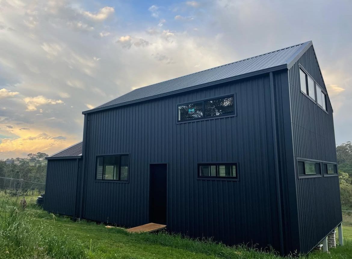 A Dark Blue House With Metal Fascia — Metal Roofing by Matt Dwyer in Nowra, NSW
