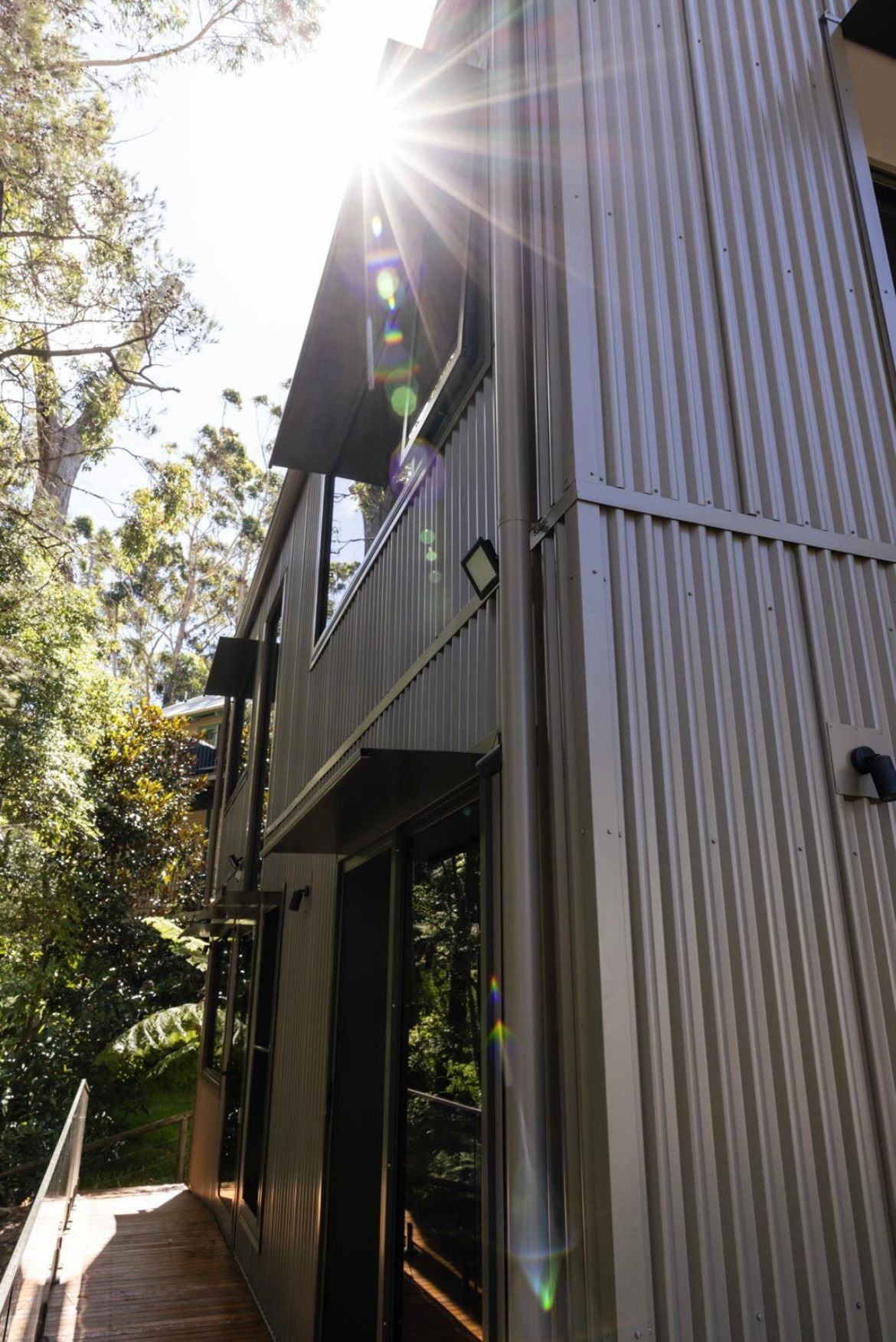 A Red Brick Building With a White Gutter on the Side — Metal Roofing by Matt Dwyer in Shellharbour, NSW