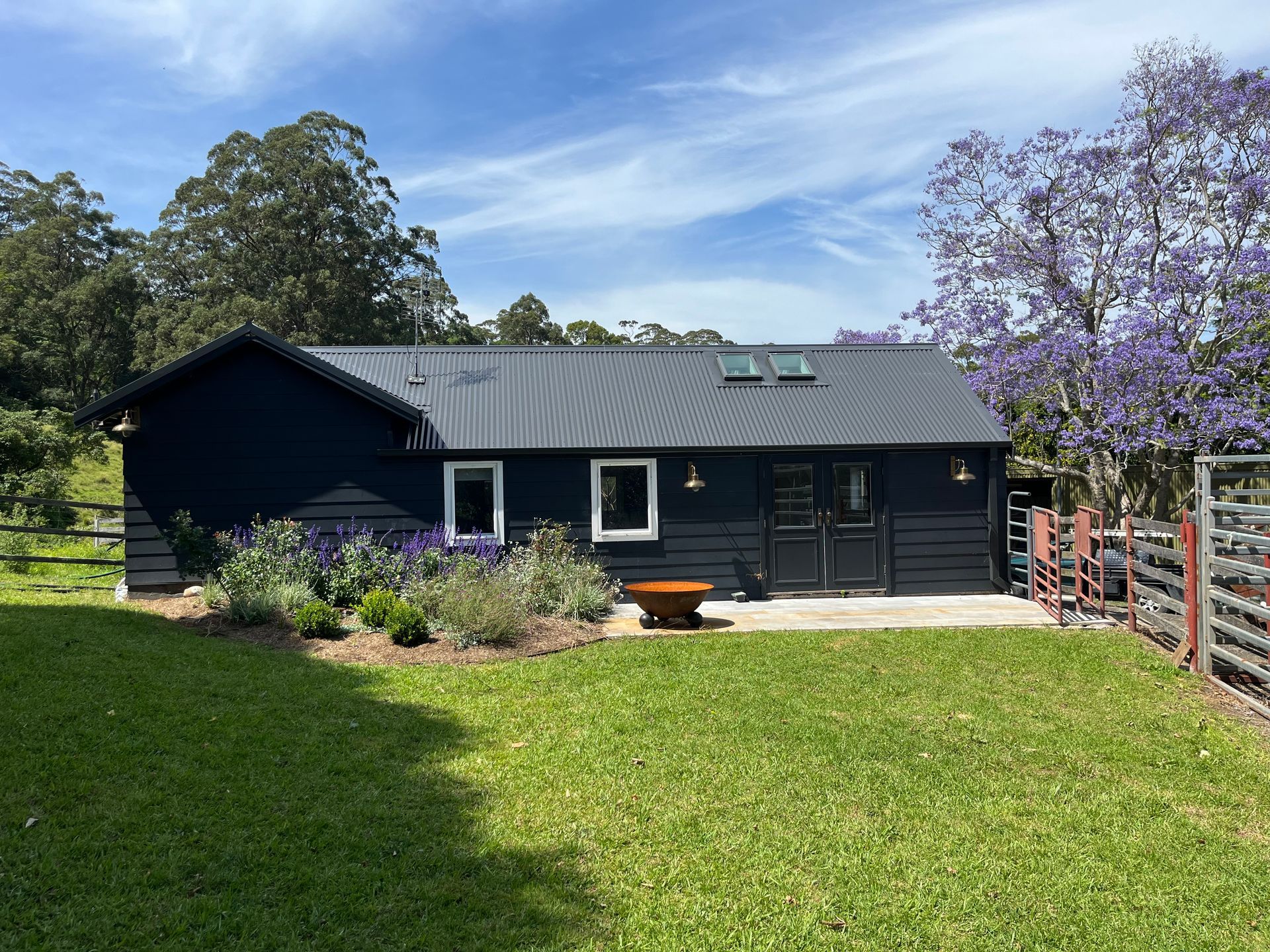A Black House With Scaffolding Around It is Being Built — Metal Roofing by Matt Dwyer in Gerringong, NSW