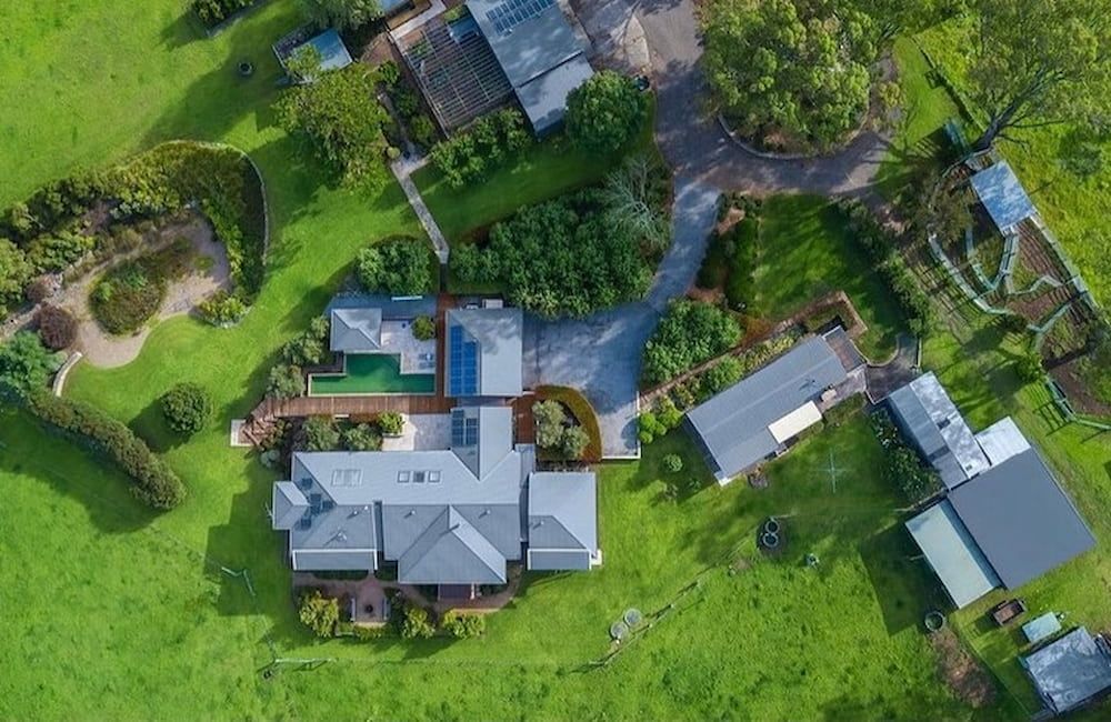 An Aerial View of a Large House in the Middle of a Lush Green Field — Metal Roofing by Matt Dwyer in Gerringong, NSW