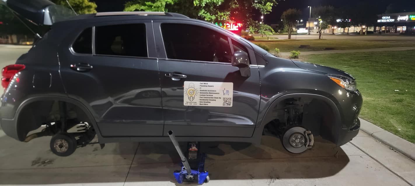 A car with a flat tire is sitting on a jack.