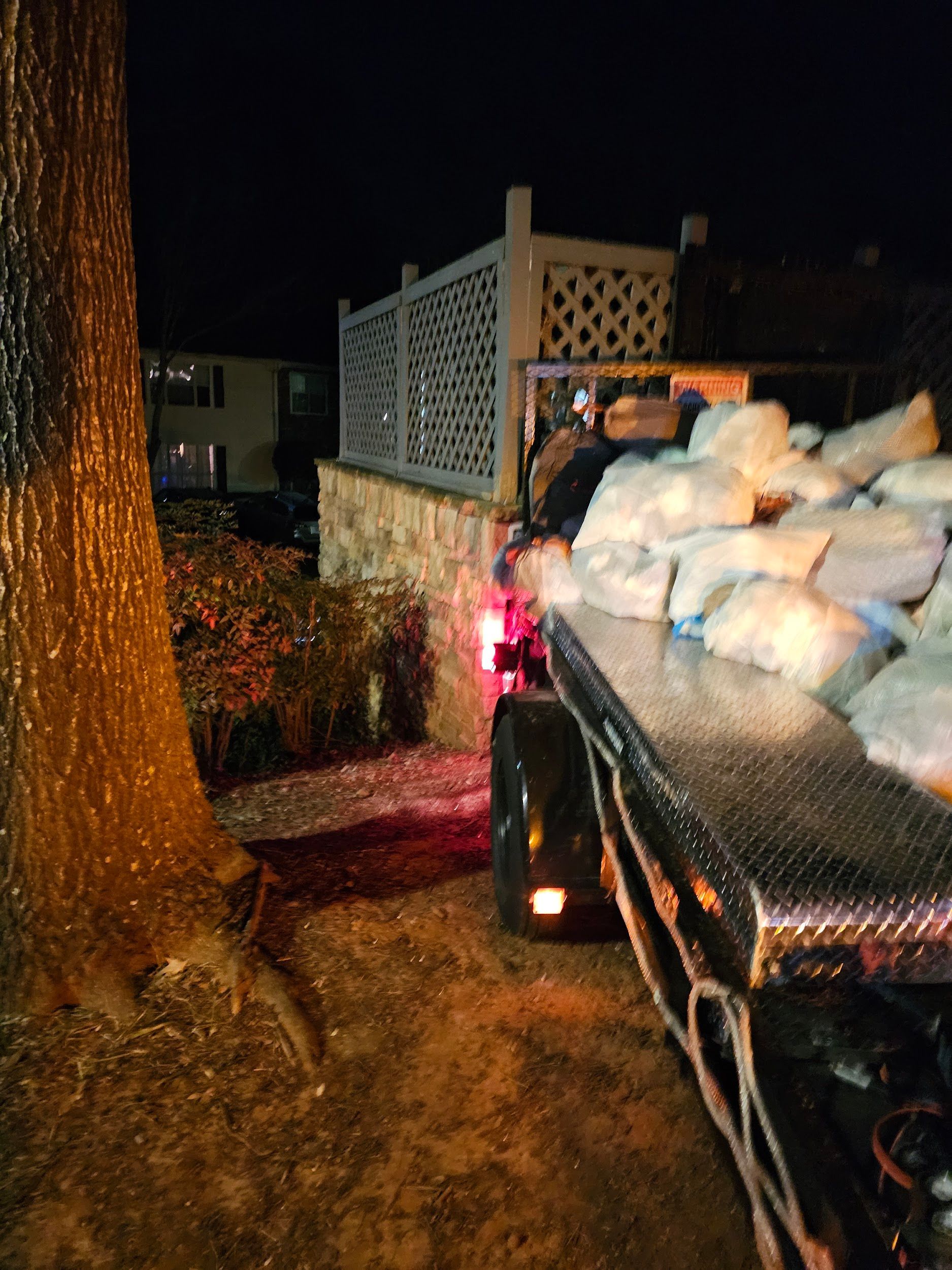 A large pile of snow is on the back of a truck.