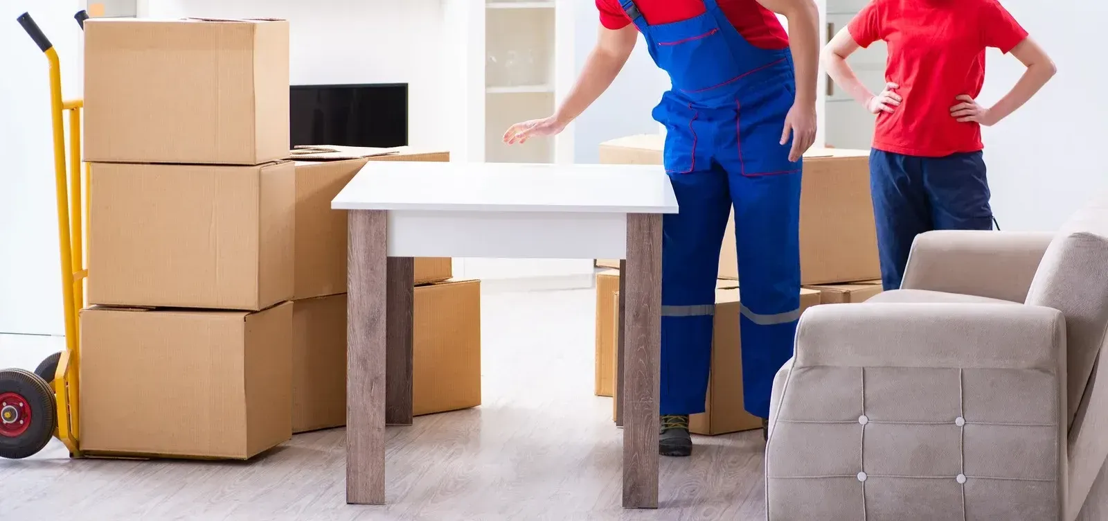 A man and a woman are moving into a new home.