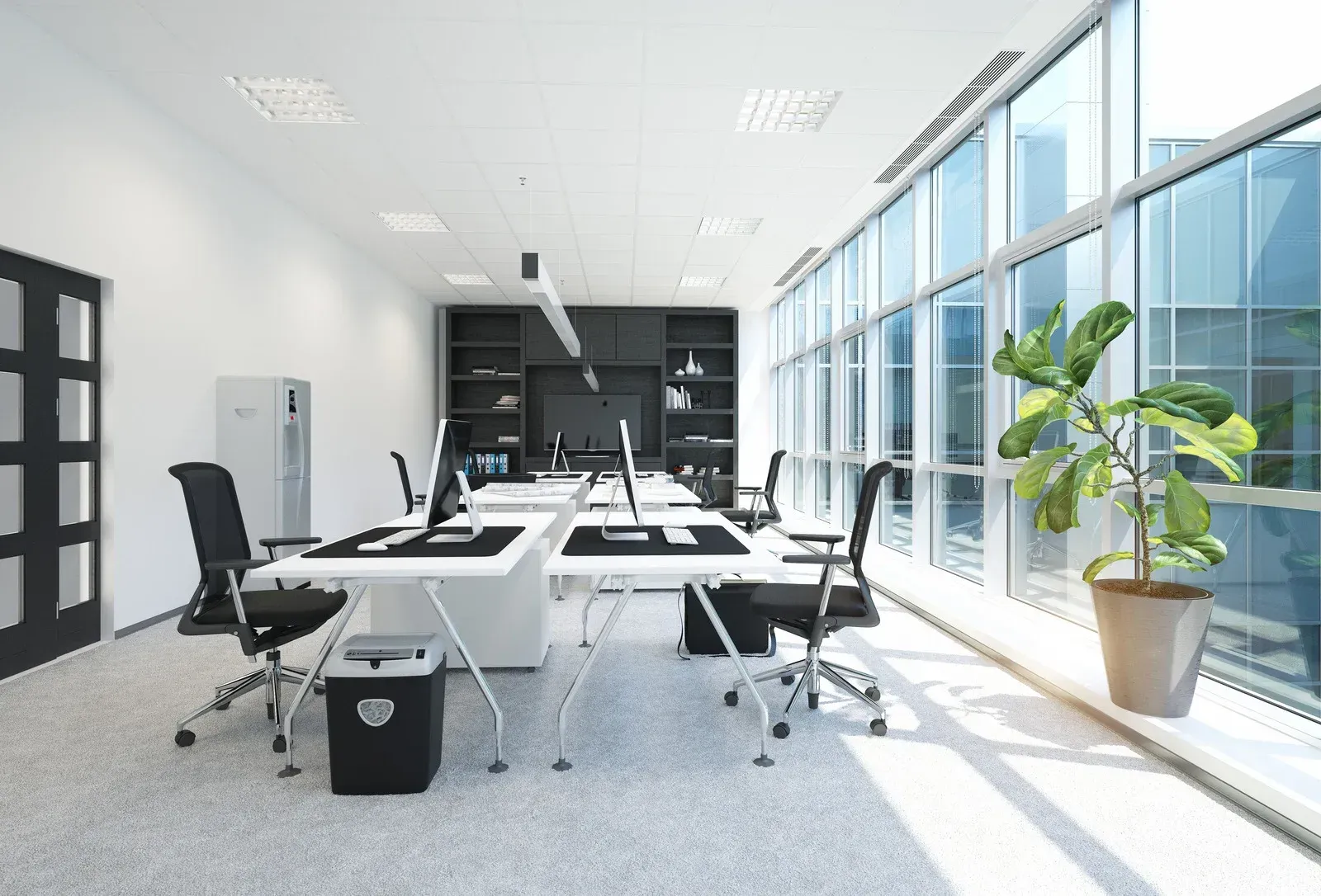 An office with a lot of windows and tables and chairs.