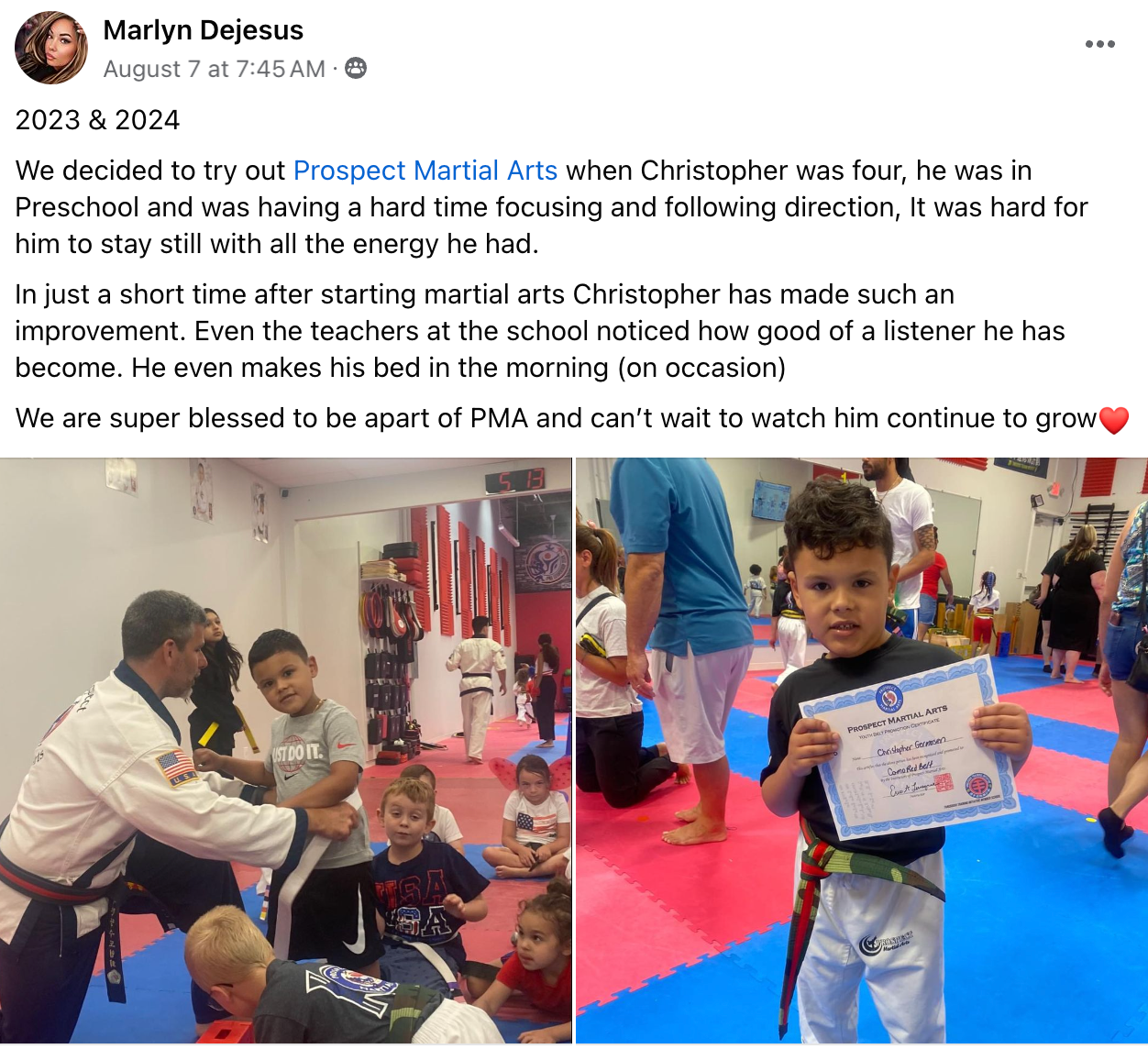 A young boy is holding a certificate in a martial arts class.