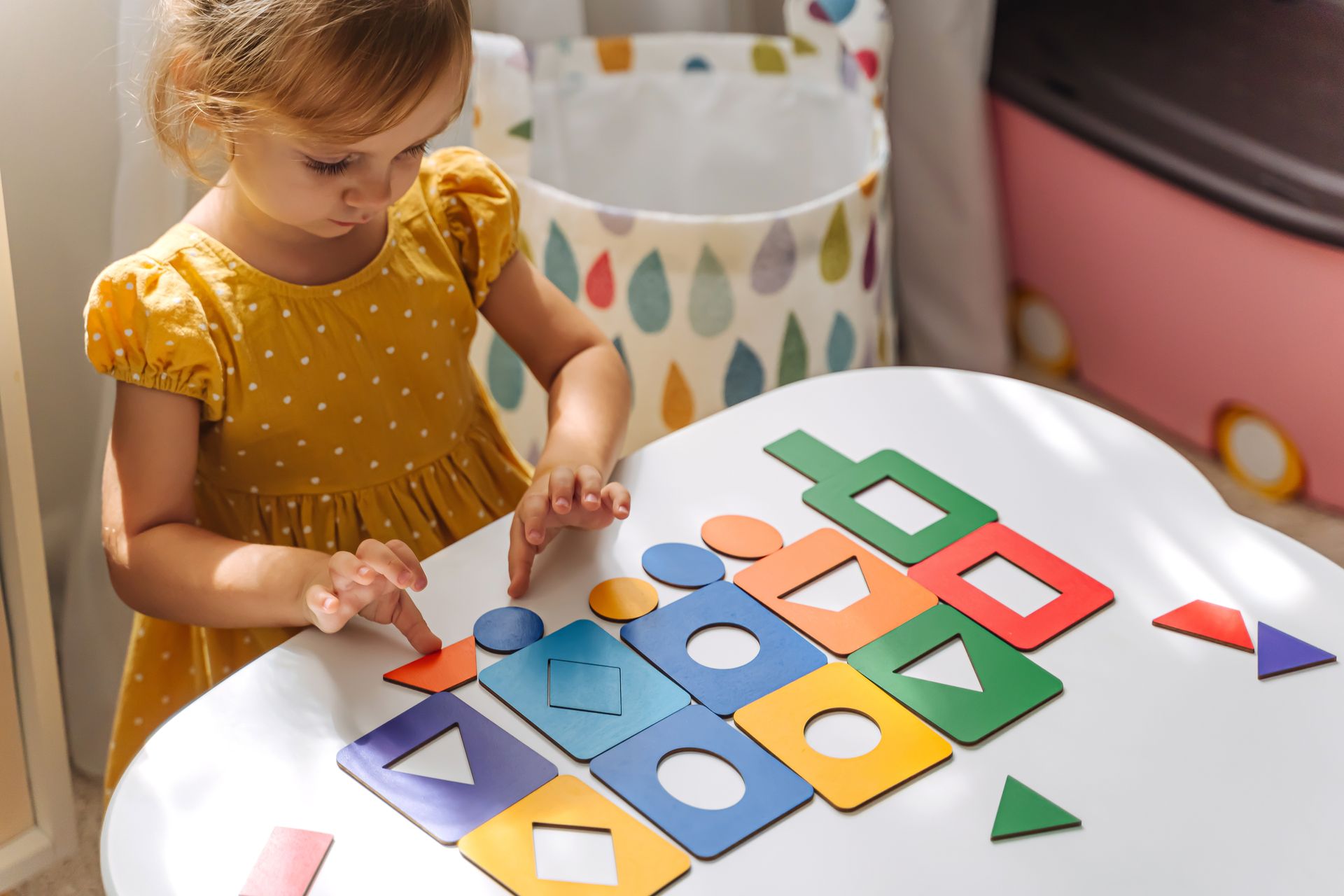 A little girl doing an activity in a Montessori classroom.