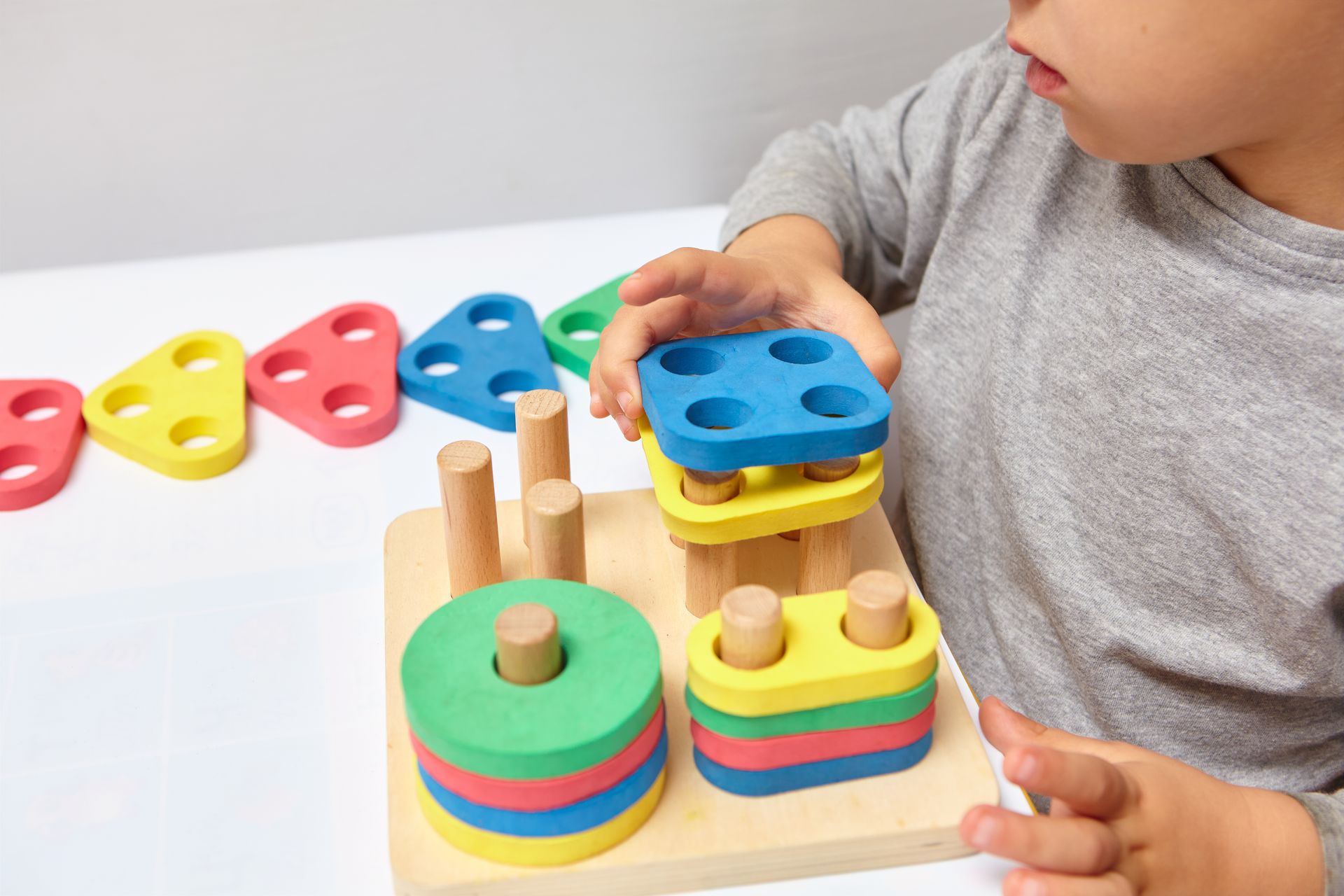 A kid playing with Montessori toys.