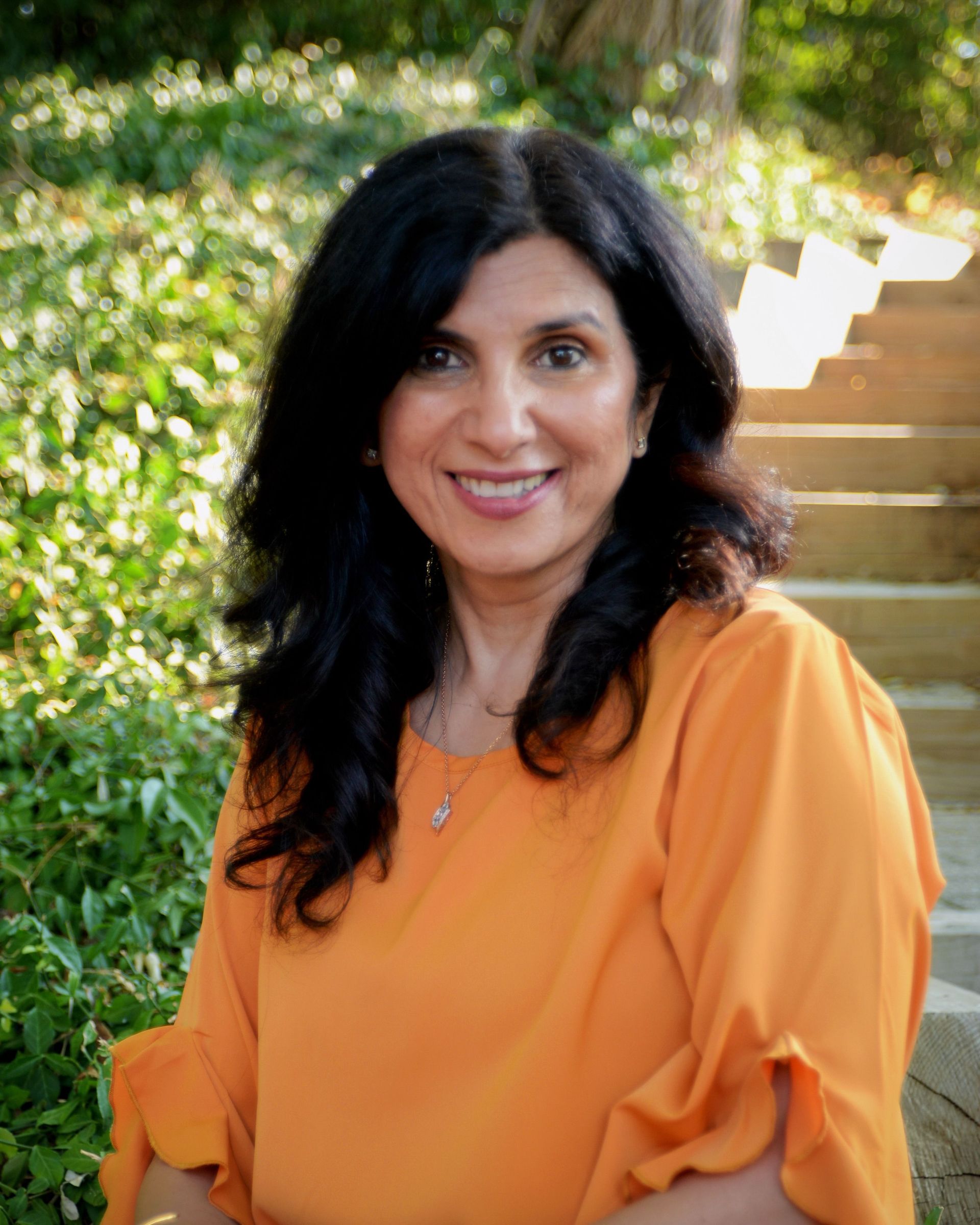 A woman in a plaid shirt is smiling in a circle.