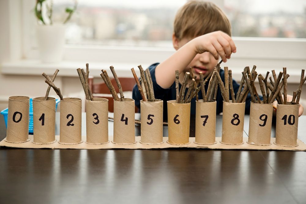 child learning to count using one-to-one correspondence activity at a Montessori