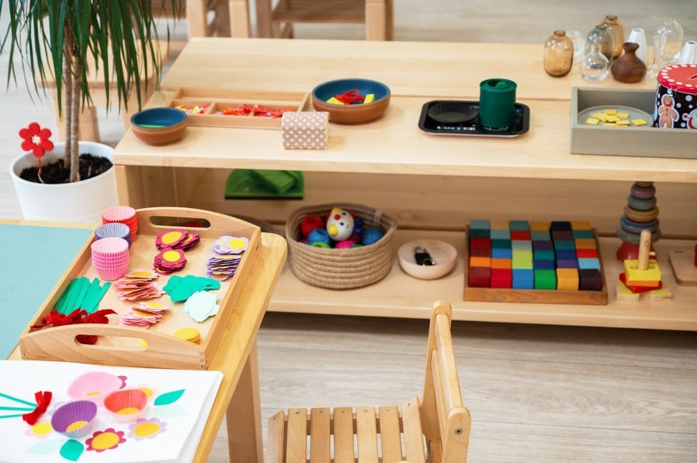 A room filled with lots of toys and a table and chair.