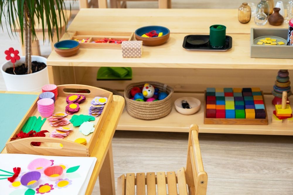 A room filled with lots of toys and a table and chair.