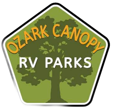 Logo for Ozark Canopy RV Parks: A pentagonal green sign with a central tree silhouette and orange and white text.