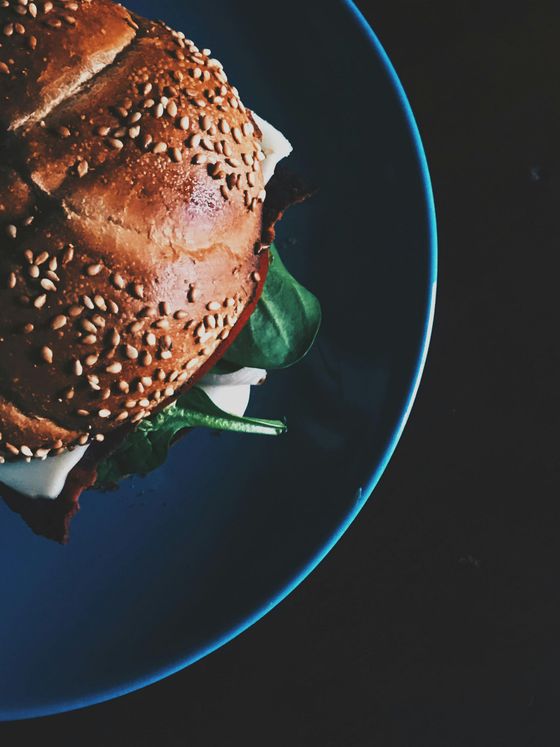 A close up of a sandwich on a blue plate