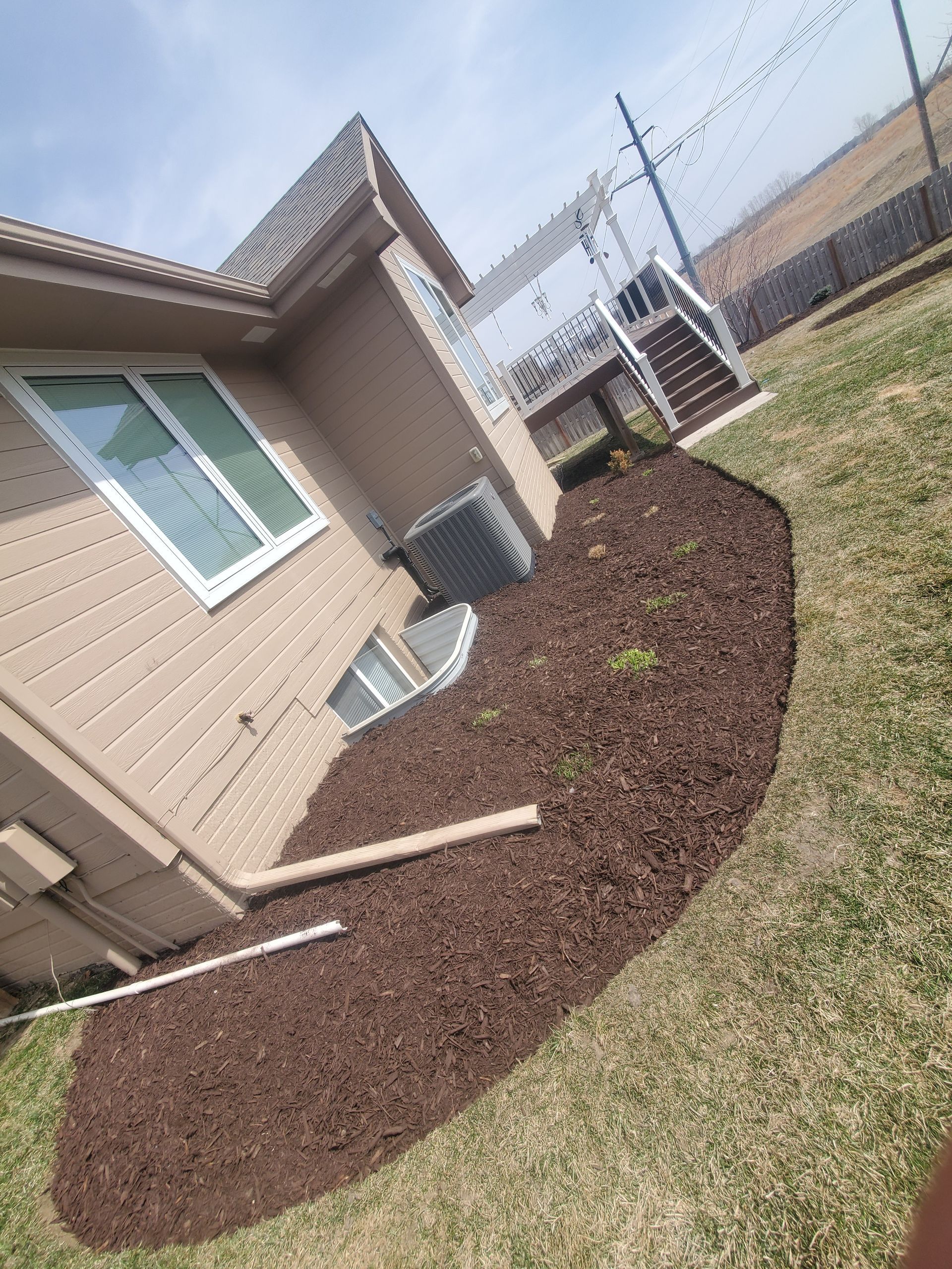 A house with a lot of mulch in front of it