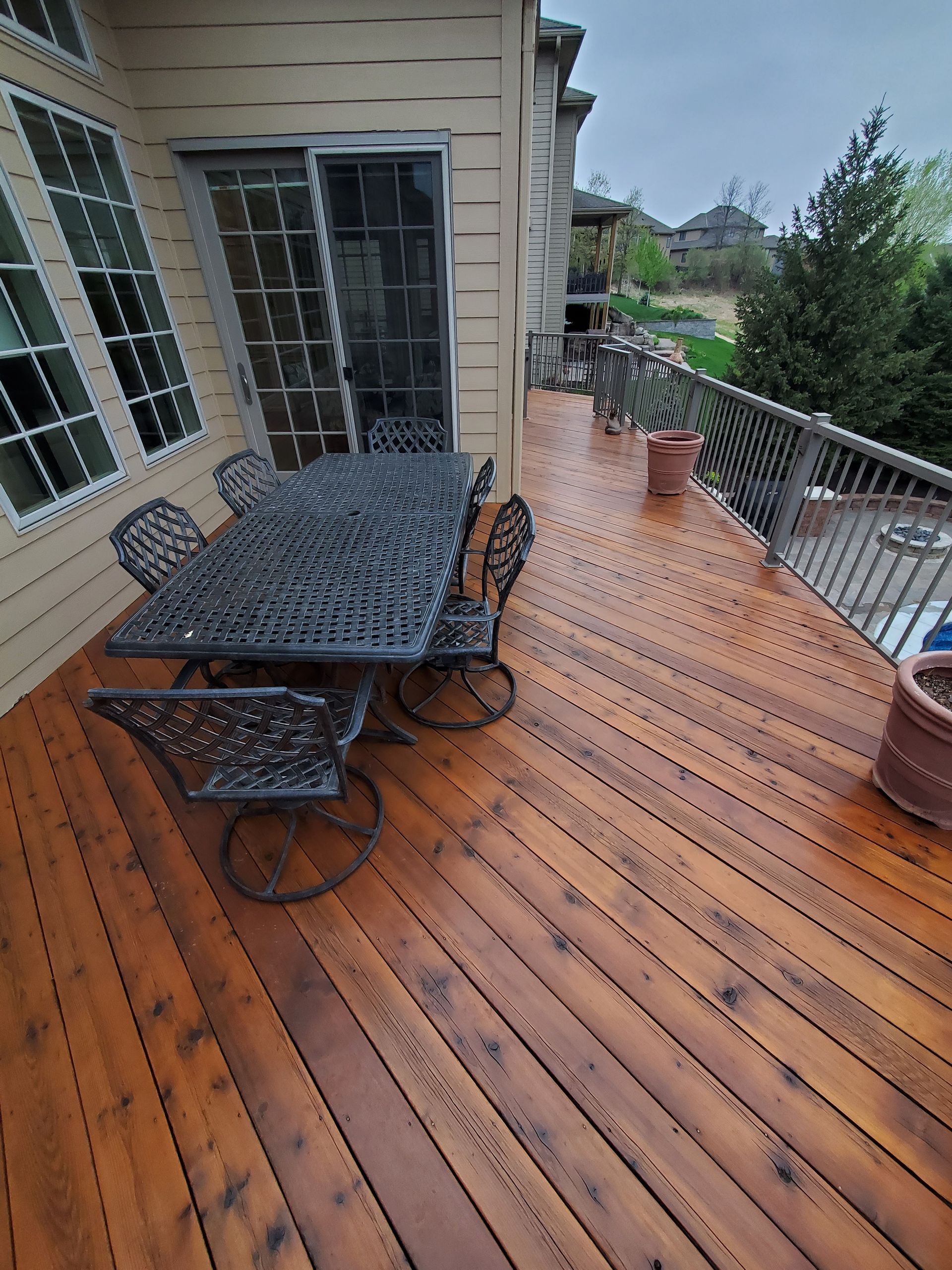 A wooden deck with a table and chairs on it.