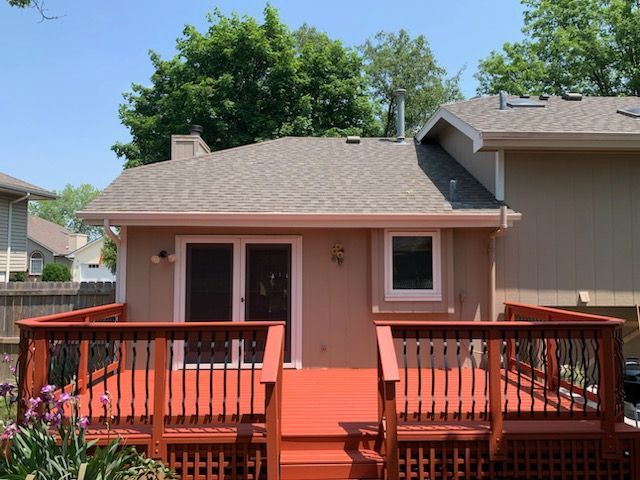 A house with a large deck in front of it